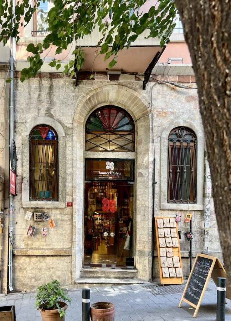 Historic stone-front bookstore in Cihangir with arched windows and stained glass showcasing the neighborhood’s artistic character.