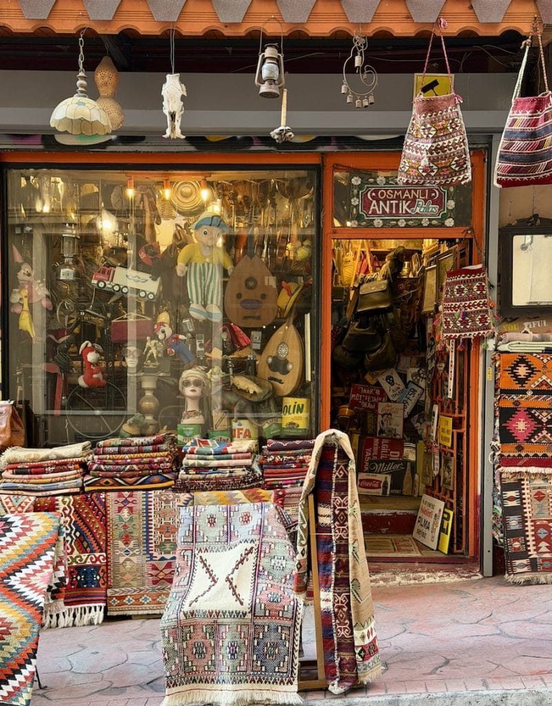 Colorful antique shop in Cihangir displaying handwoven carpets and retro collectibles in one of Istanbul’s most eclectic neighborhoods.