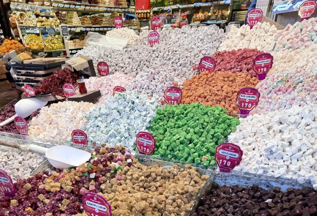 Market stall piled high with colorful Turkish delight cubes in different flavors and textures