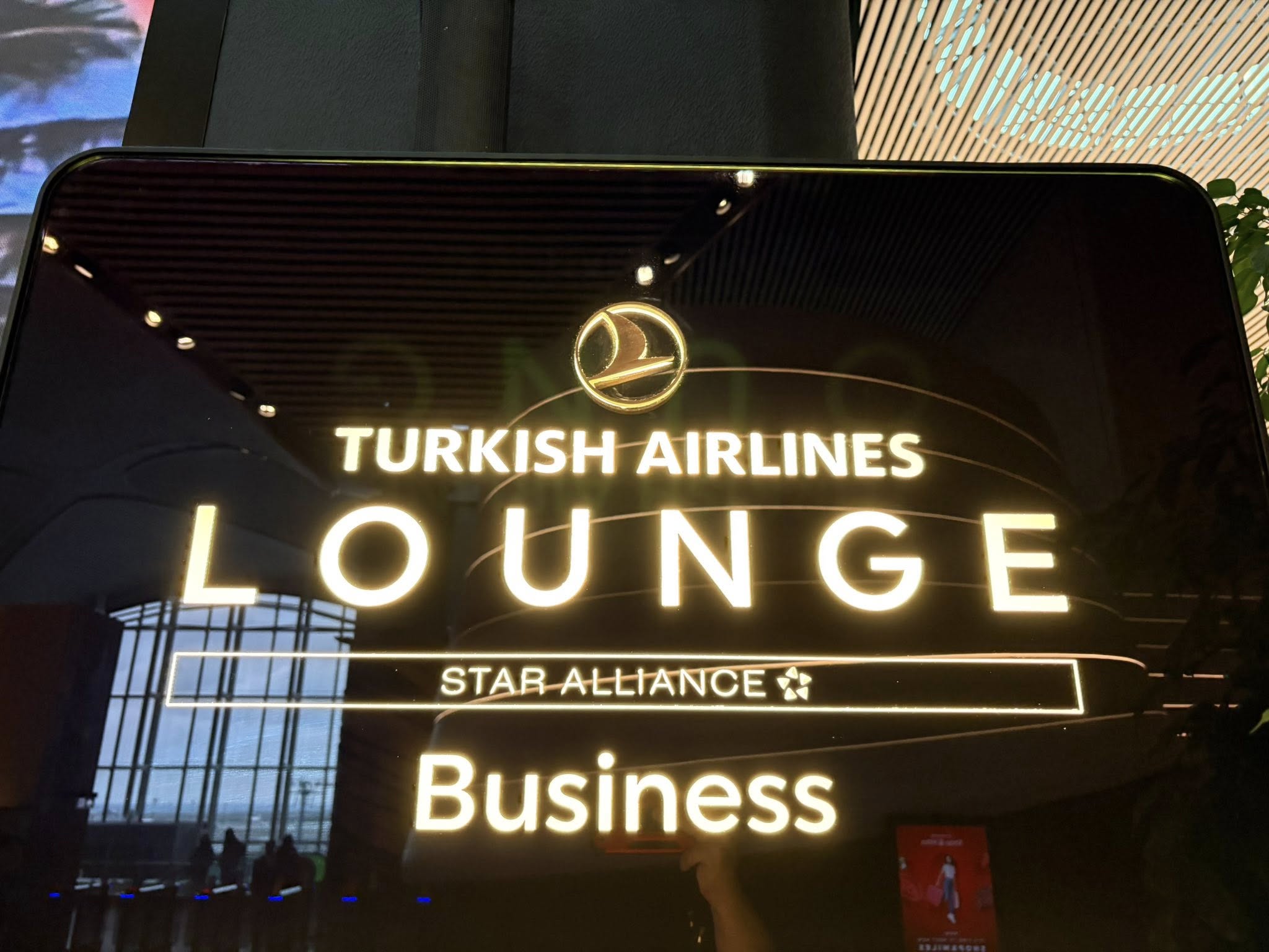 Illuminated sign reading "TURKISH AIRLINES LOUNGE STAR ALLIANCE Business" inside Istanbul Airport highlighting lounge access during a long Istanbul layover.